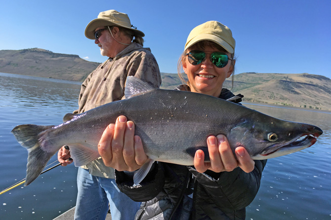 Two people showing of their catch of fish with Blue Mesa Fishing in Gunnison, Colorado