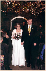 Colorado Wedding with bride and groom walking below romantic lights