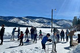 Families ice skating on Vallecito Lake near Bear Paw Lodge, Cabins, and Vacation Homes in Durango, Colorado.