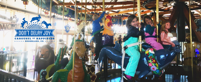 Kids riding on the famous carousel at The Carousel of Happiness in Nederland, Colorado.