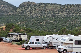 RVs and trailers parked in camping sites with full hookups at Indian Springs Ranch and Campground in the Royal Gorge area of Colorado.