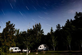 Dark night sky full of stars above RV camping sites at LaVern Johnson RV Park and Campground in Lyons near Estes Park, Colorado.